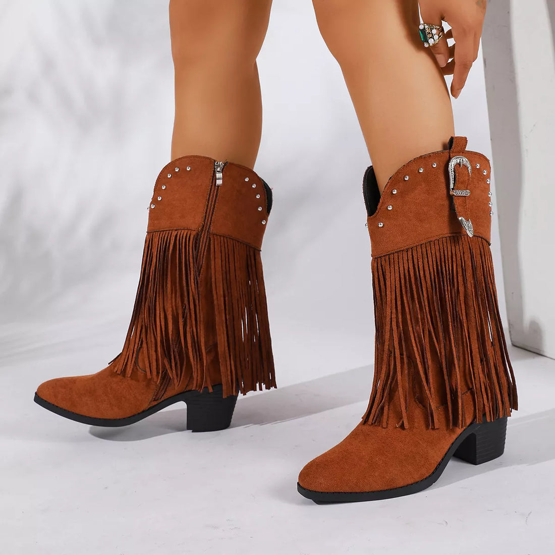 Orange fringe round-toe block-heel boots with studded strap and ankle buckle