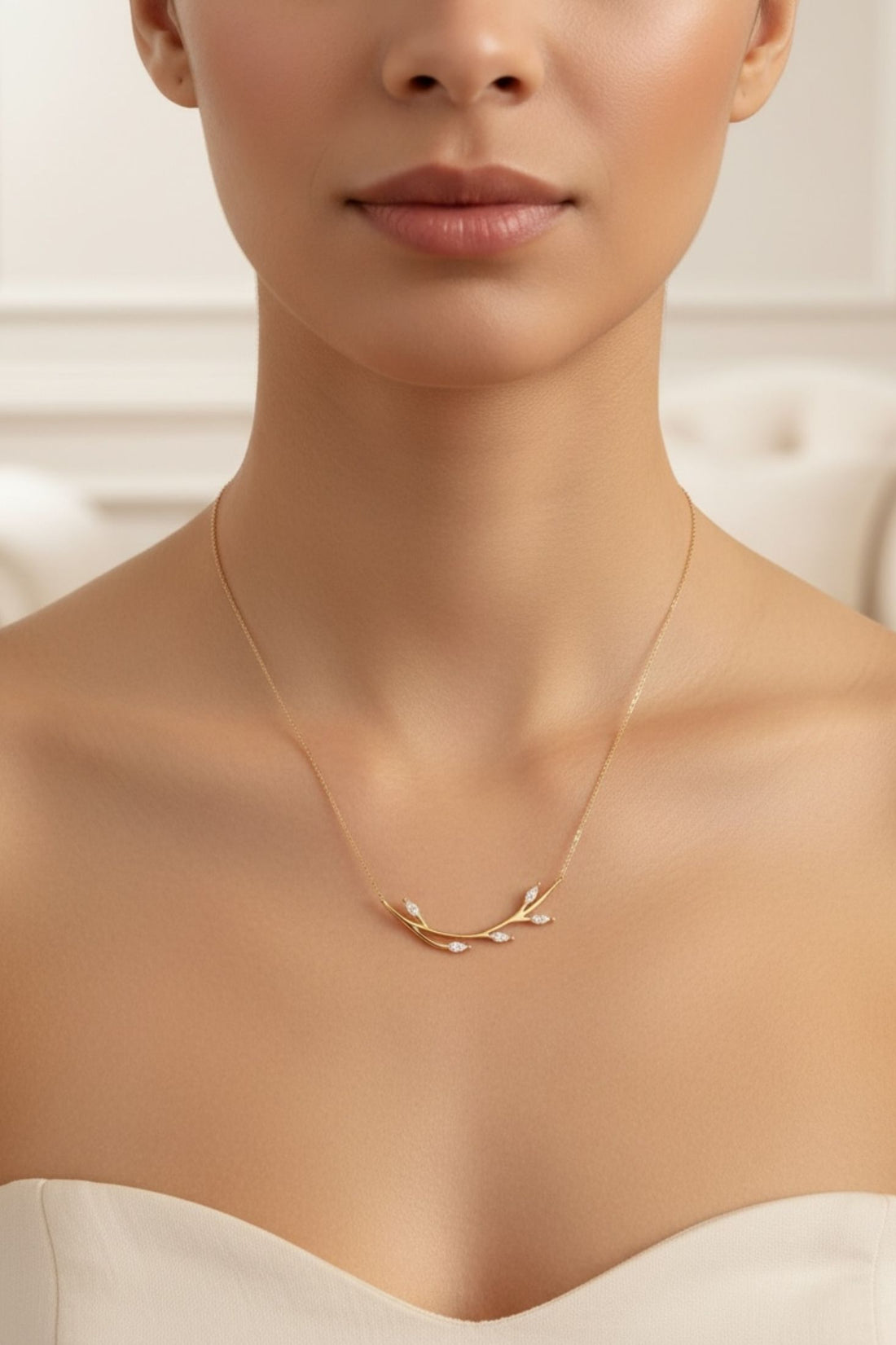 14k gold blooming branch necklace on model, small branch pendant at center