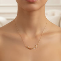 14k gold blooming branch necklace on model, small branch pendant at center