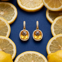 Pair of gold citrine oval drop earrings with crystal halo