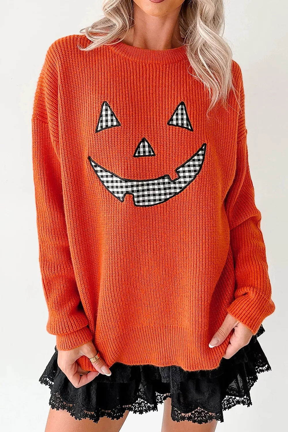 Orange knit long-sleeve sweater with jack-o-lantern face and round neckline