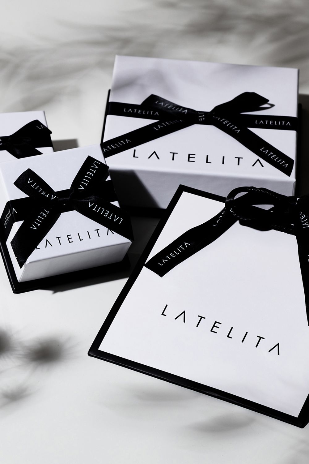 Bracelet gift packaging with LATE LITA branded boxes and black ribbon bows