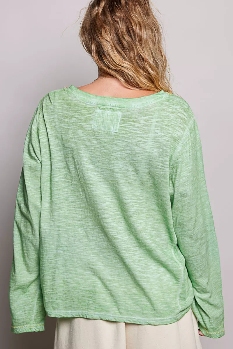 Light green knit long sleeve top with V-back and front pocket detail