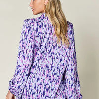 Purple printed balloon-sleeve shirt with ruffle trim at neckline, side view