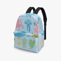 Kids canvas backpack with blue sea creature print and black adjustable shoulder straps.