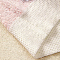 Ribbed knit hem and cuffs on dusty pink sweater in textured knit fabric