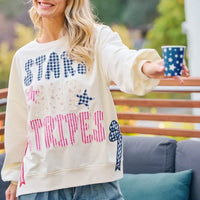 Cream crewneck sweatshirt with stars-and-stripes patch-style graphic, front detail