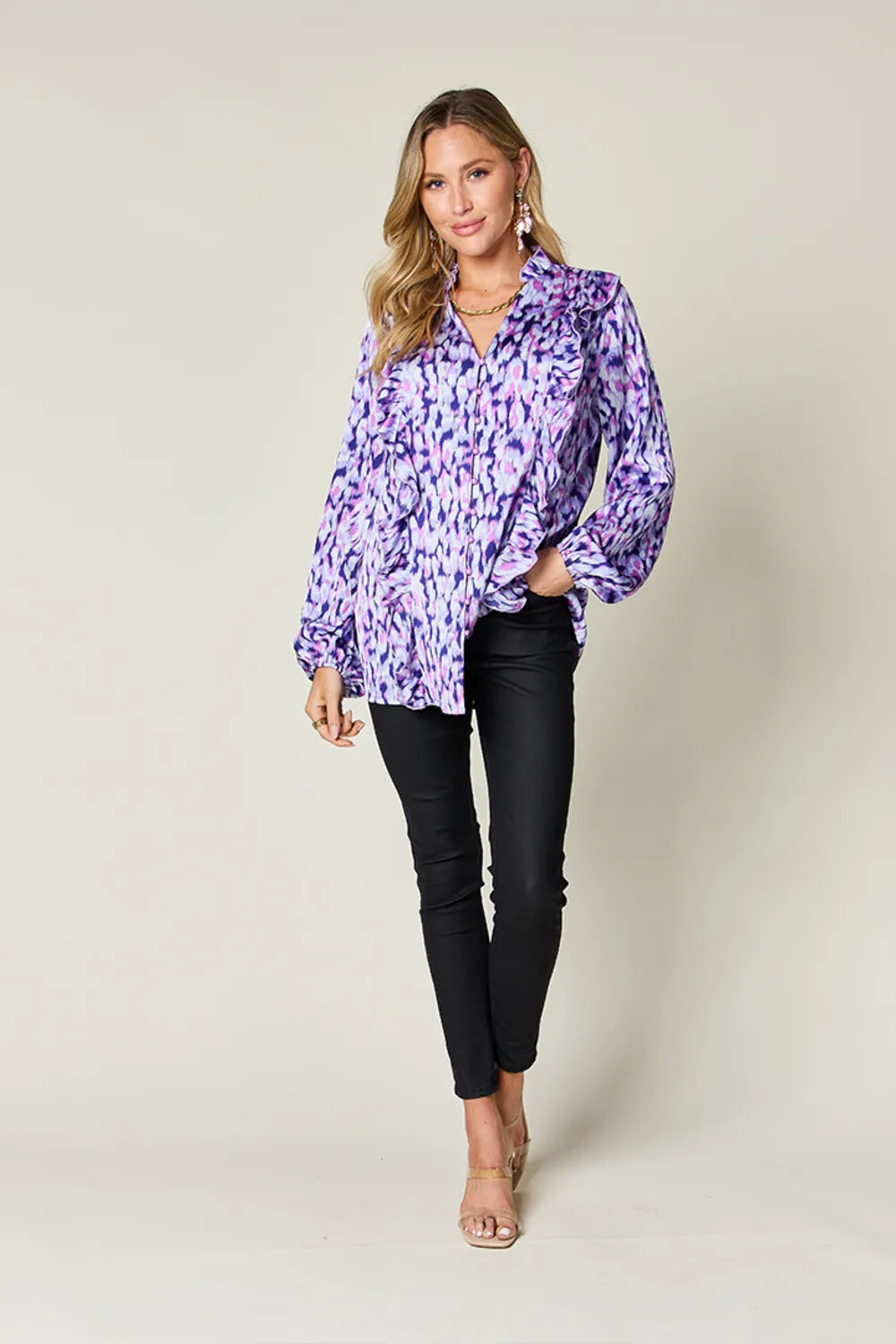Purple printed button-up shirt with ruffle V neckline and balloon sleeves, full body
