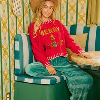 Red Christmas sequin lettering sweater with white trim and gold “MERRY & BRIGHT”