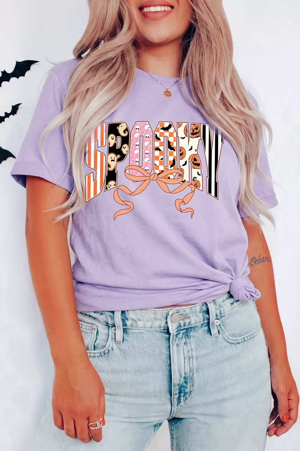 Lavender purple crew-neck T-shirt with Halloween letter graphic and bow design
