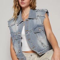 Light wash denim vest with asymmetrical button front, distressed patches, flap pockets