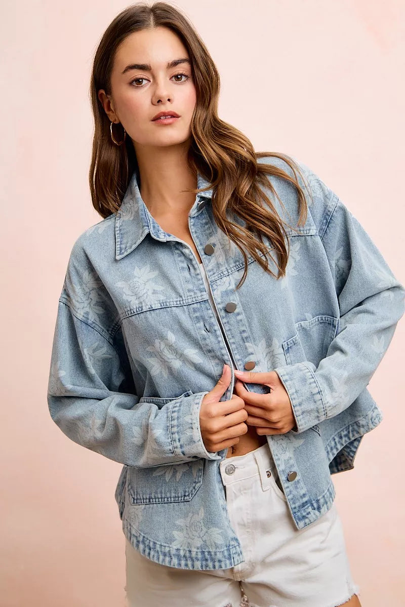 Light blue denim jacket, button-front with white floral print and front pockets