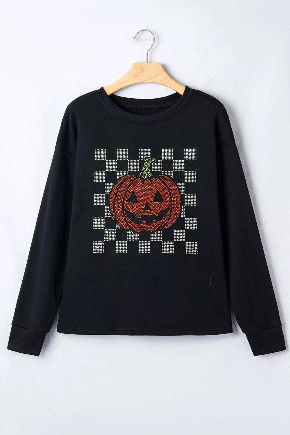 Black long sleeve sweatshirt on hanger, checkerboard rhinestone pumpkin front