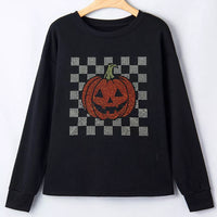 Black long sleeve sweatshirt on hanger, checkerboard rhinestone pumpkin front
