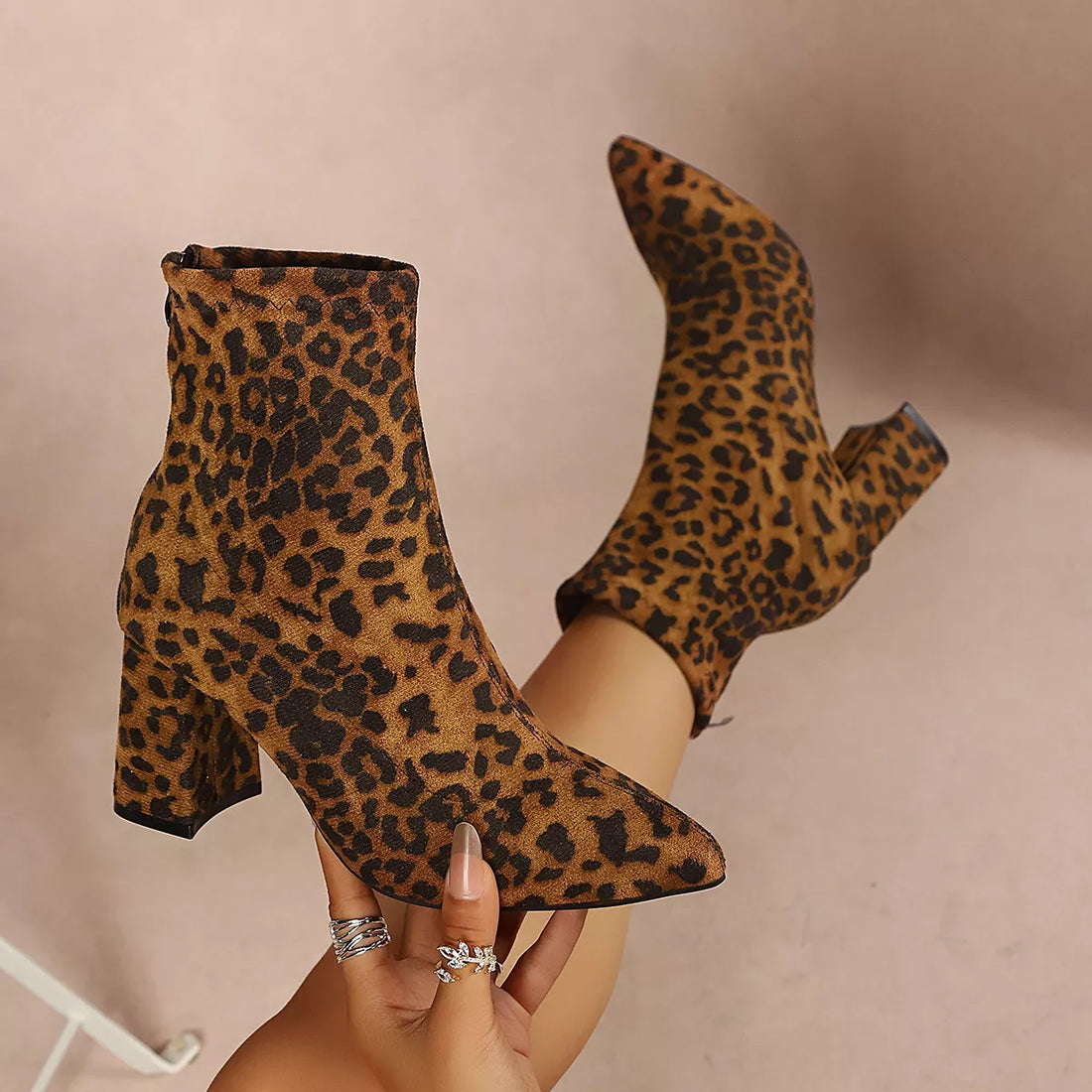 Leopard print point-toe block-heel ankle boots, angled view of thick heel