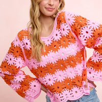 Orange and pink floral crochet top with wide scalloped hem and long sleeves.