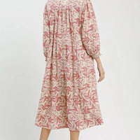 Back view of tiered midi dress with pink botanical print and long sleeves