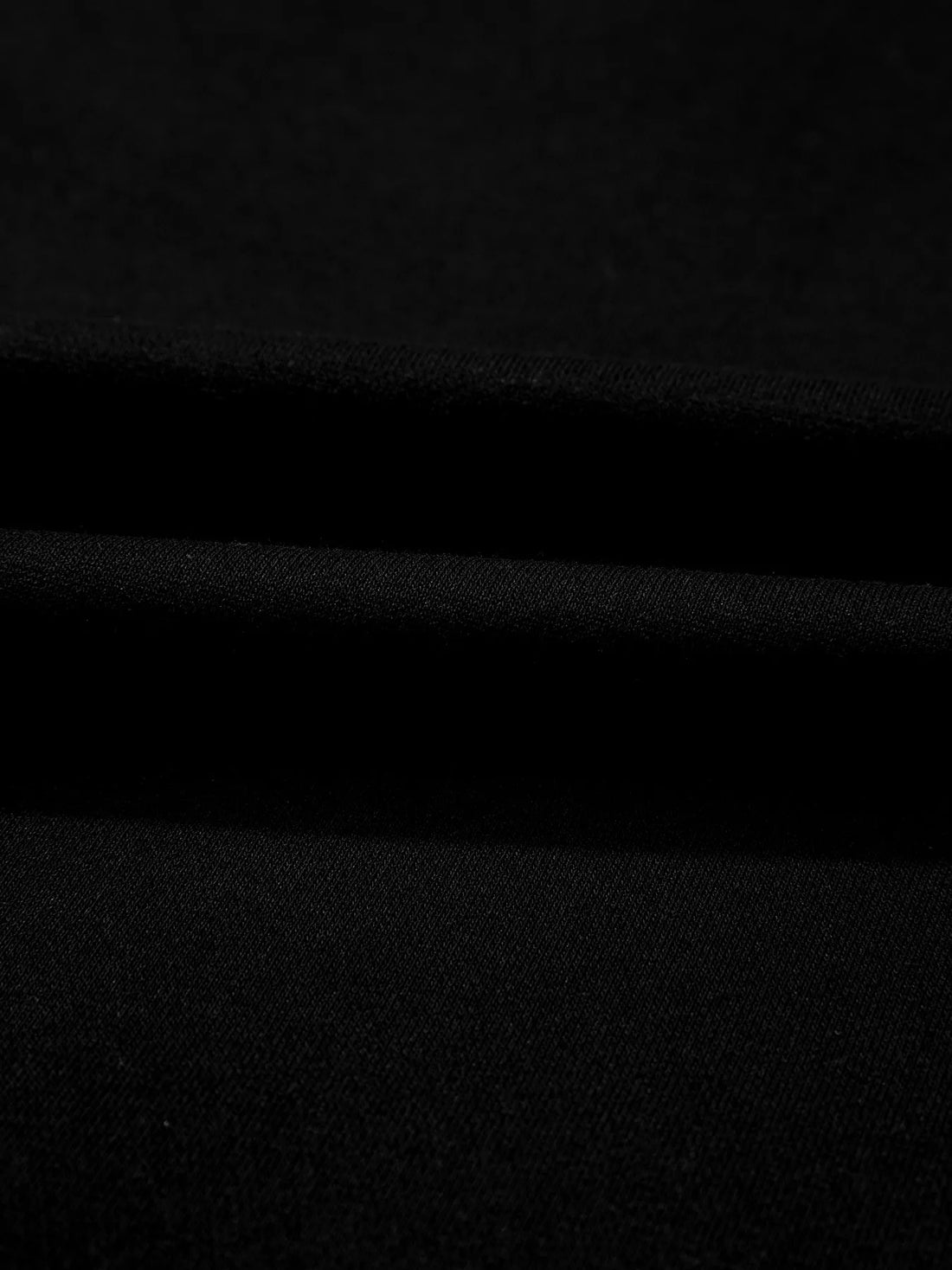 Close-up of black knit fabric with soft matte texture