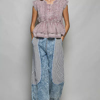 Pink sleeveless embroidered peplum blouse with pintuck front, gathered waist, and ruffle hem.