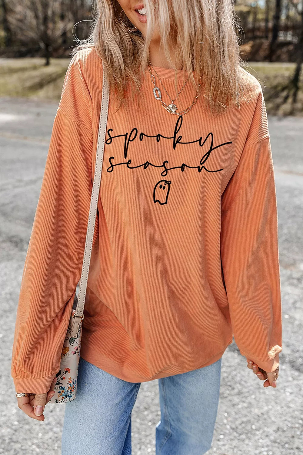 Orange ribbed pullover sweatshirt with spooky “sprooky season” text and ghost graphic