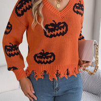 Orange V-neck pumpkin sweater with black jack-o’-lantern pattern and frayed hem detail