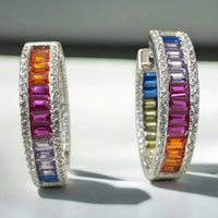 Silver hoop earrings featuring rainbow baguette gemstone stripe and shimmering border