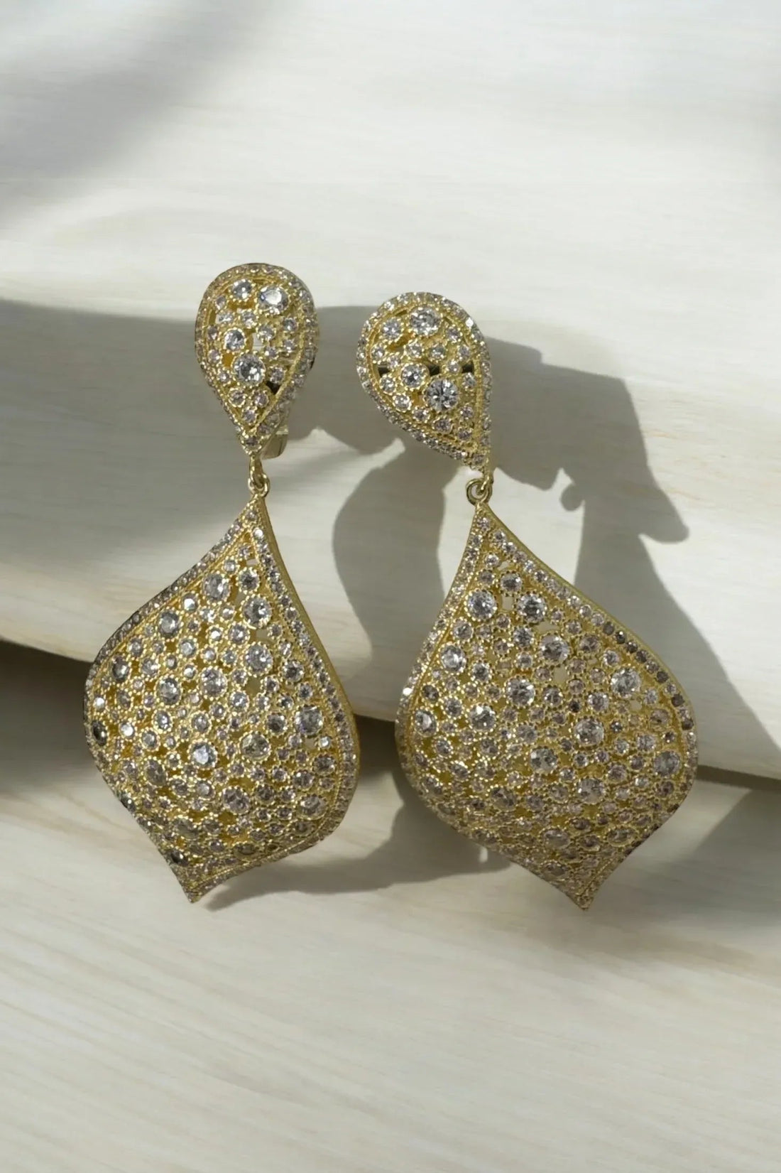 Gold teardrop dangle earrings with pavé clear stones