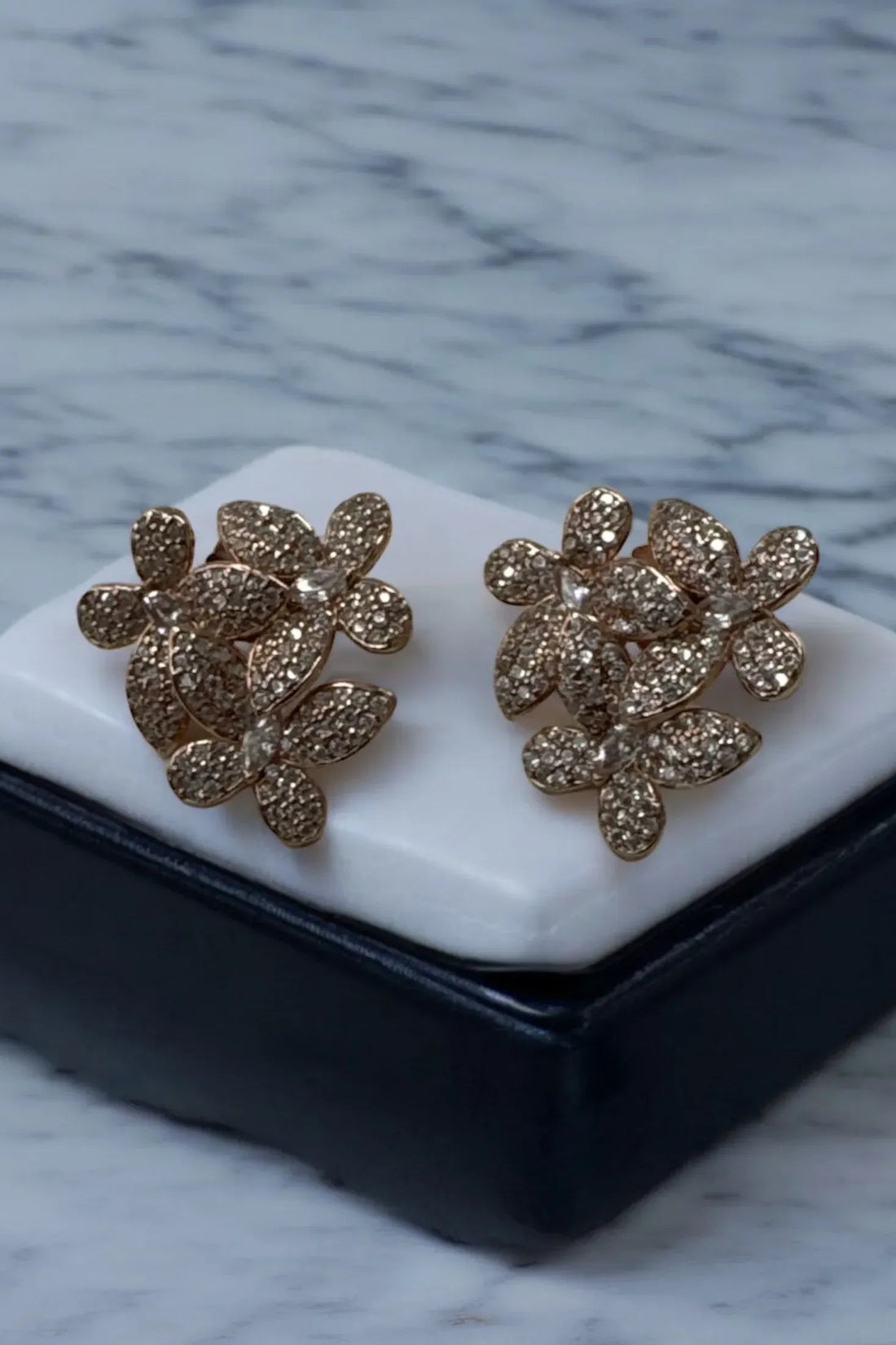 Gold-tone sparkling floral stud earrings with petal cluster design