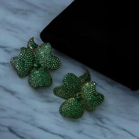 Flower stud earrings with gold-tone setting and emerald green crystals