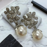 Crystal flower cluster earrings with white pearl drops, silver-toned
