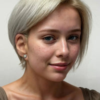 Small blue evil eye stud earrings on model, gold-tone studs