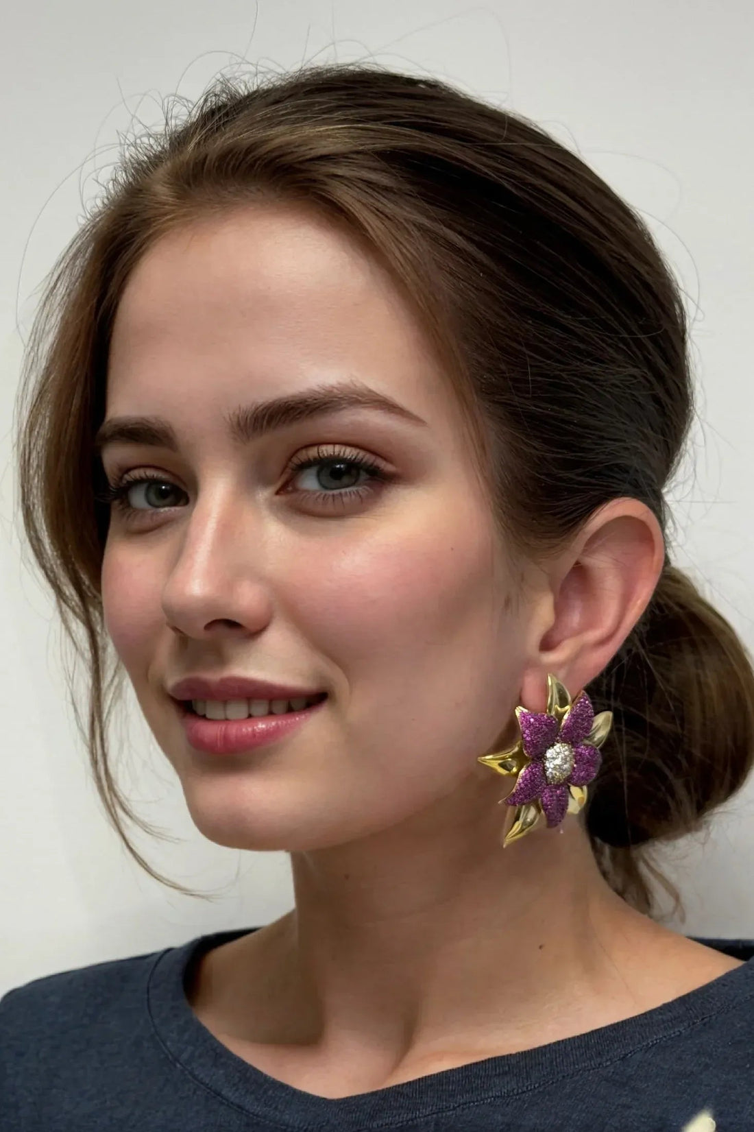 Purple flower stud earrings with gold-tone edges and white crystal center