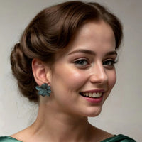 Aqua flower stud earrings on silver-tone posts, worn with an updo hairstyle