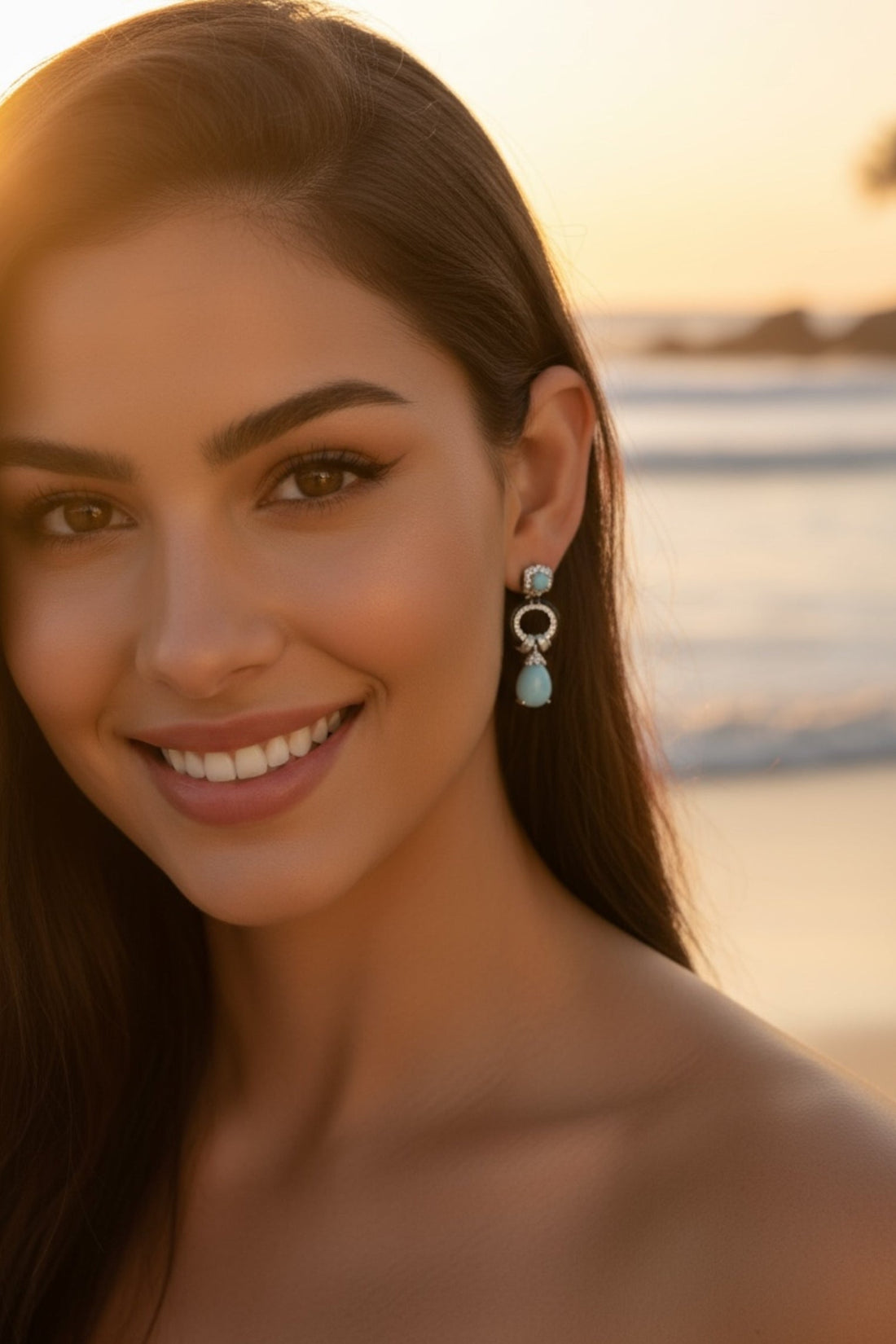 Turquoise teardrop drop earrings on model, silver-tone with black enamel ring and studs