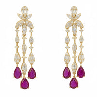 Gold drop earrings with floral crystal settings and dangling purple teardrop stones