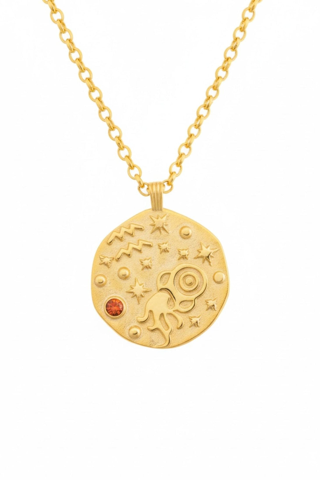 Gold-tone necklace with round zodiac-style pendant and orange gemstone detail