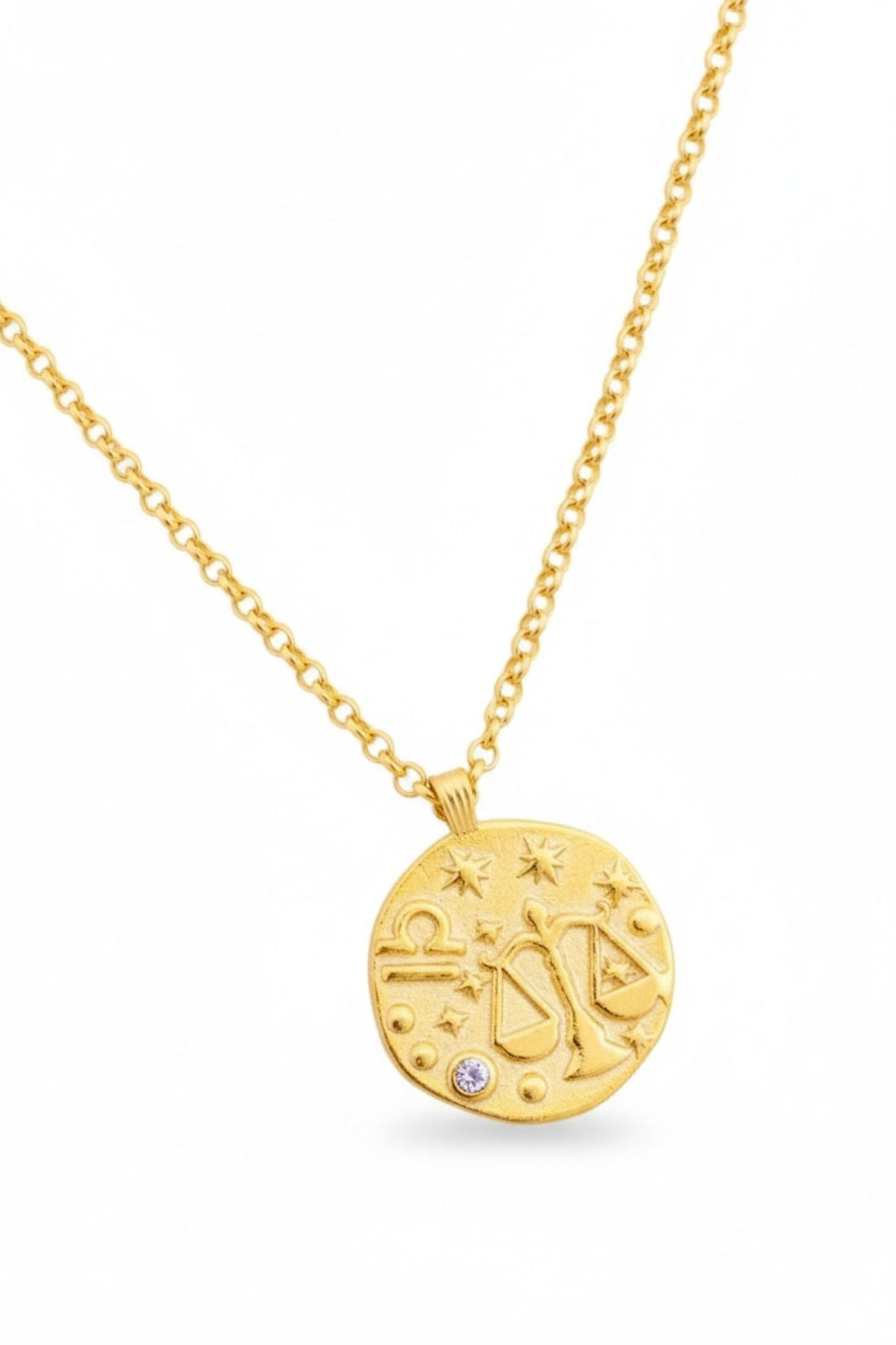 Gold zodiac talisman necklace with round Libra pendant and blue crystal, pendant close-up