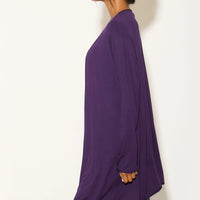 Purple waterfall cardigan, side view with long draped hem over jeans