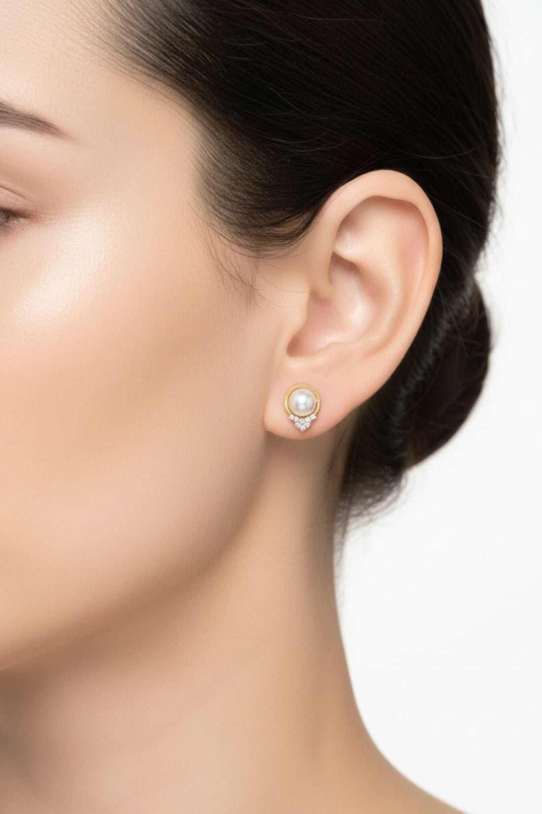 14k gold pearl and diamond earrings on ear, round pearl halo with crystal drop