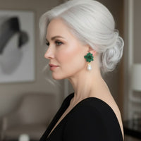 Green flower and baroque pearl drop earrings worn by model