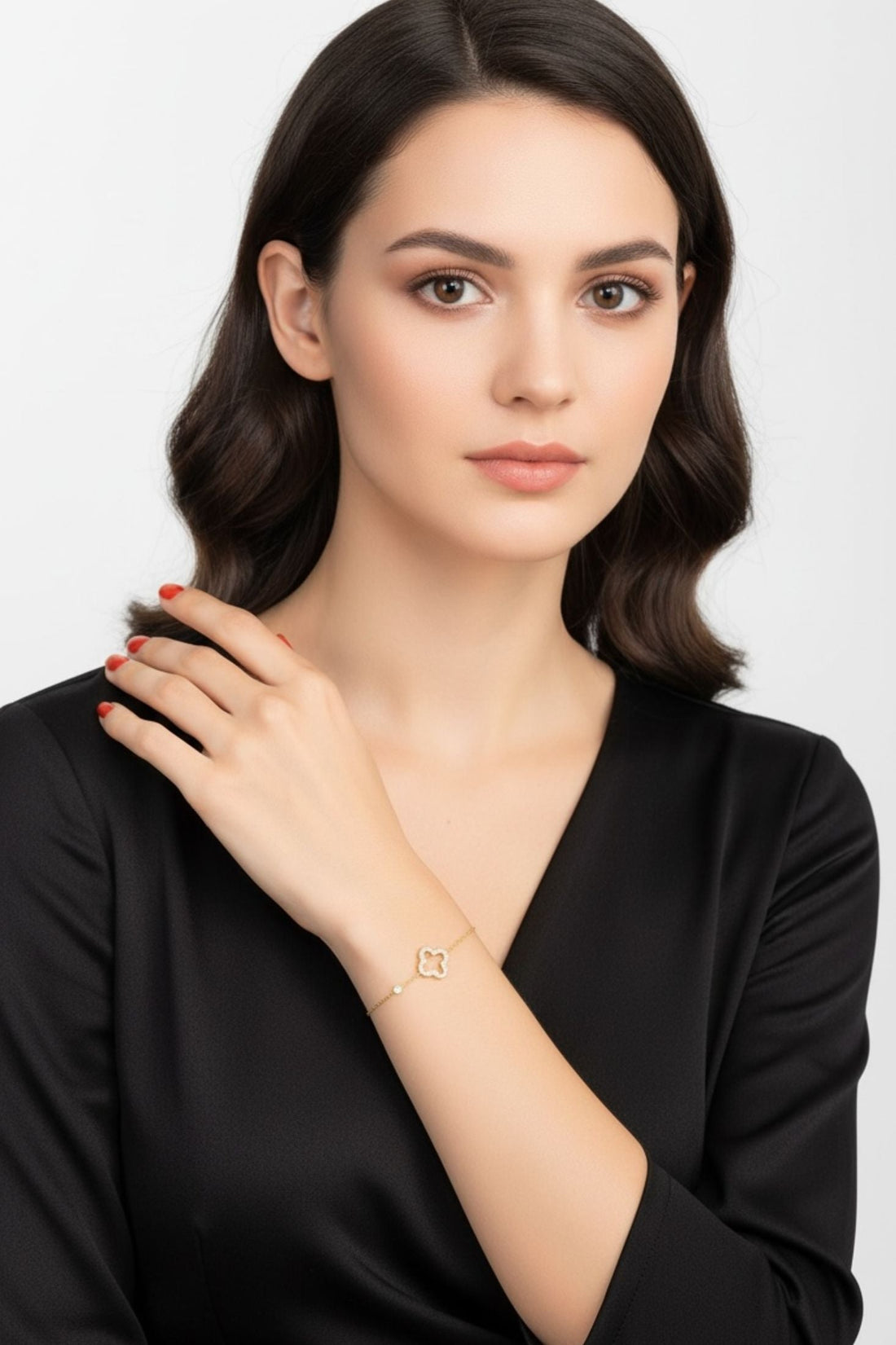 Gold open clover charm bracelet worn on model&