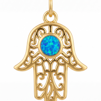 Gold hamsa hand filigree pendant with bright blue opal-style center stone