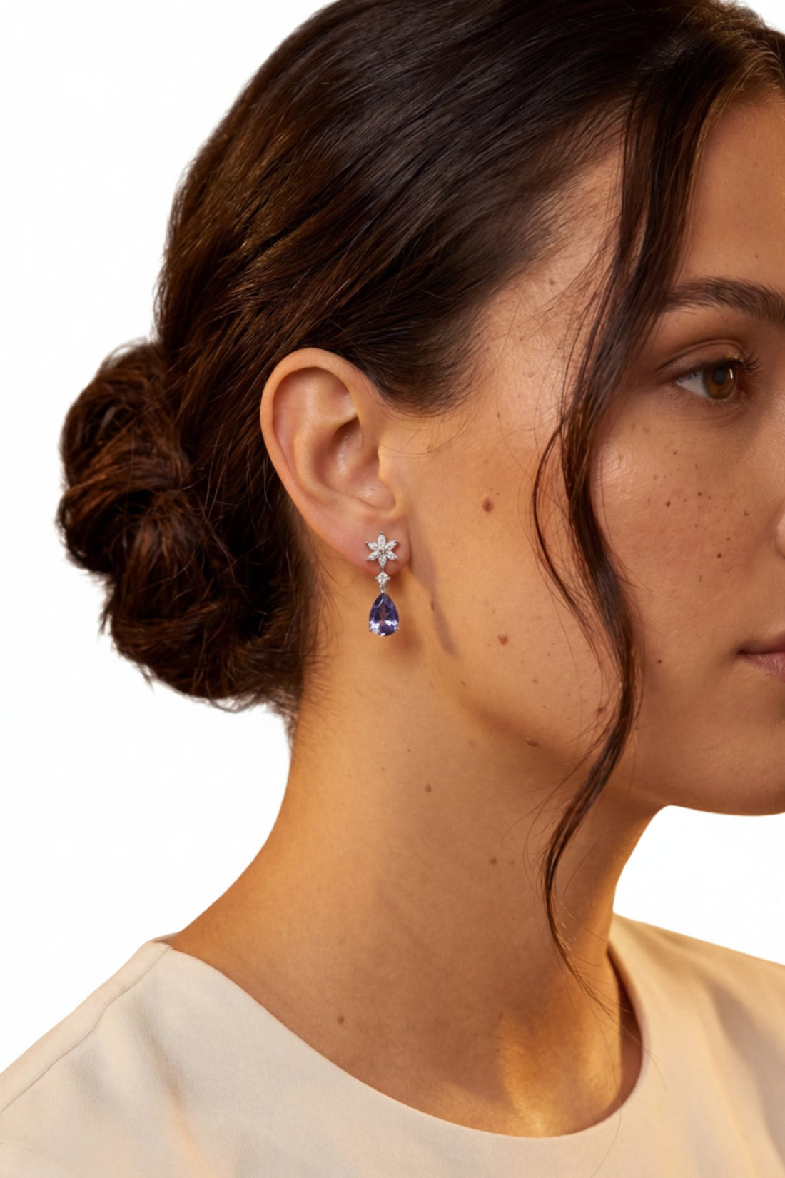 Silver drop earrings on model: crystal starburst and deep blue teardrop dangle