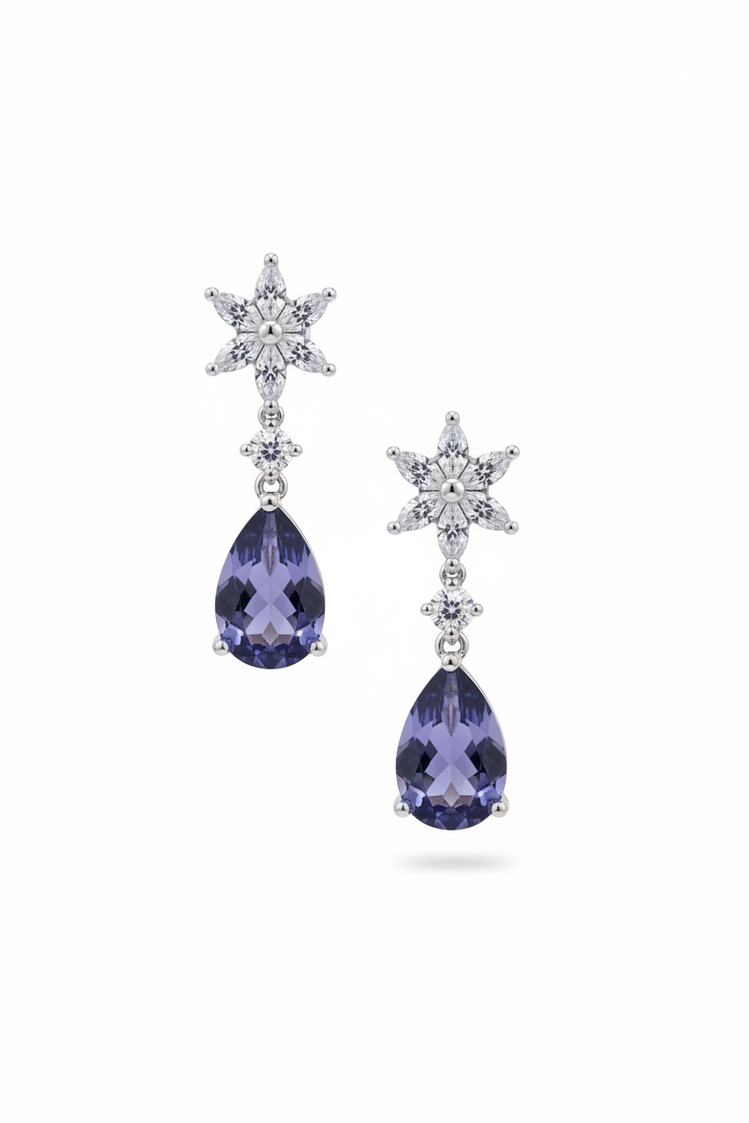 Silver crystal starburst drop earrings with deep blue teardrop stones