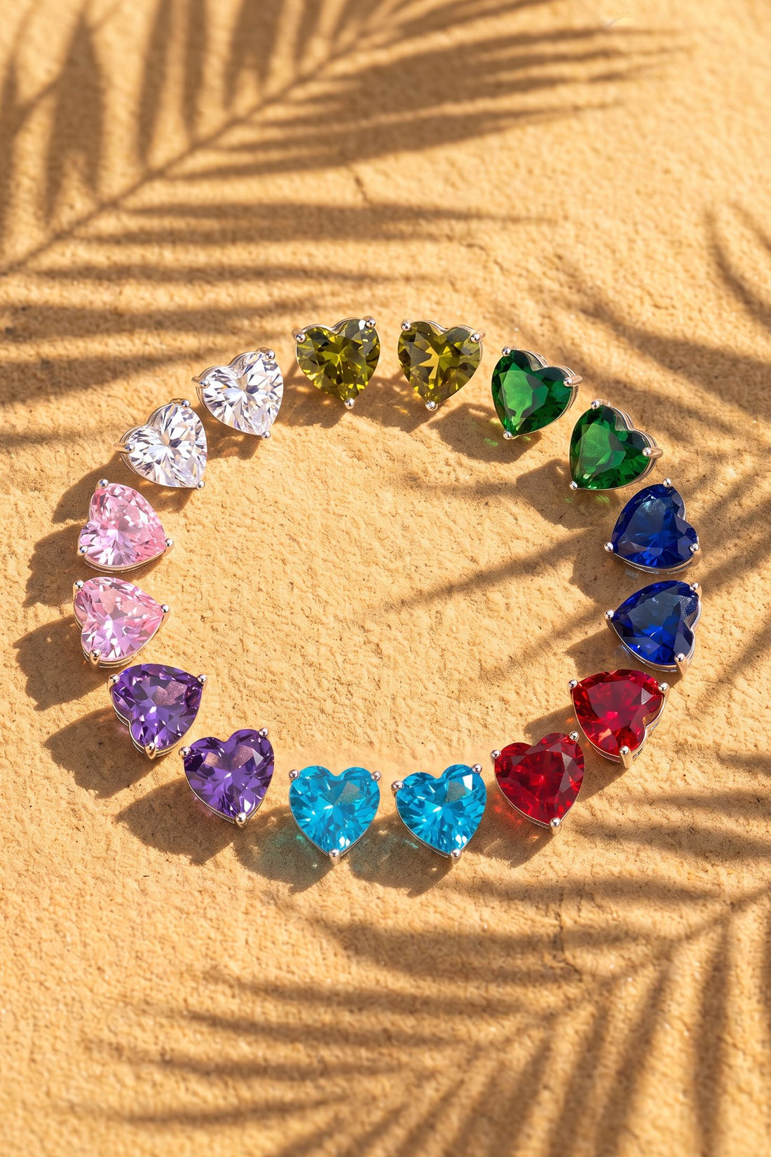 Heart-shaped gemstone stud earrings arranged in a circle with mixed colors