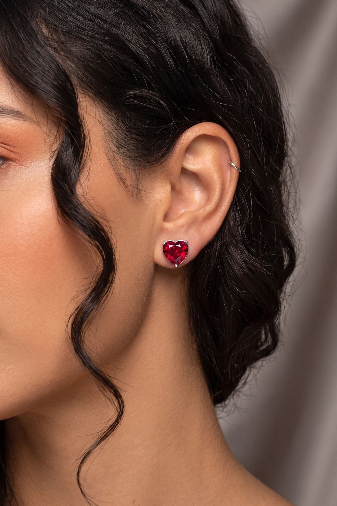 Red heart stud earrings with garnet-like stones and silver backs on ear