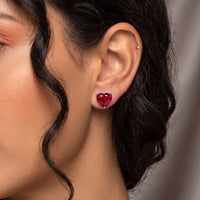 Red heart stud earrings with garnet-like stones and silver backs on ear