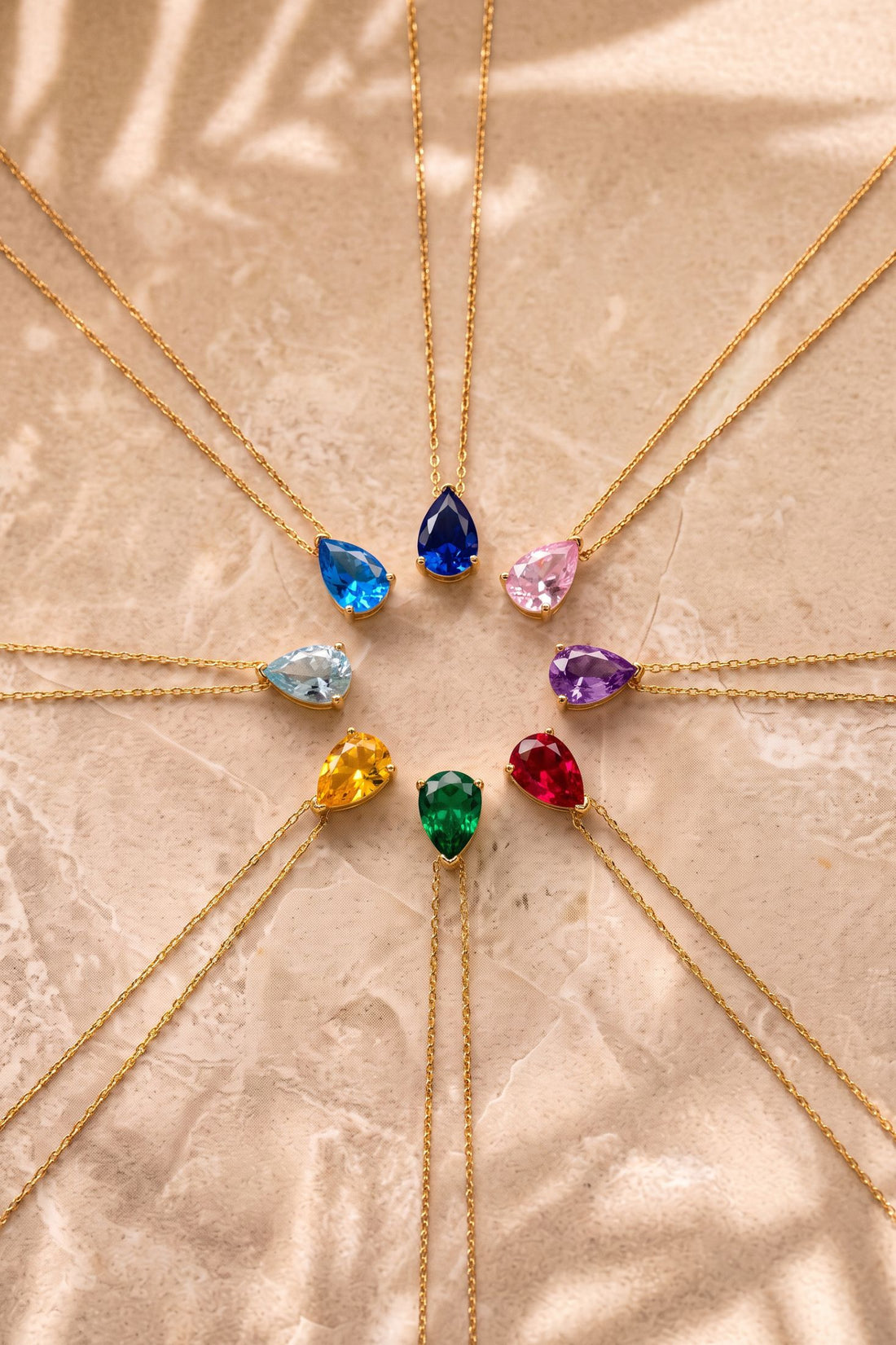 Gold chain necklace with assorted multicolor teardrop gem pendants
