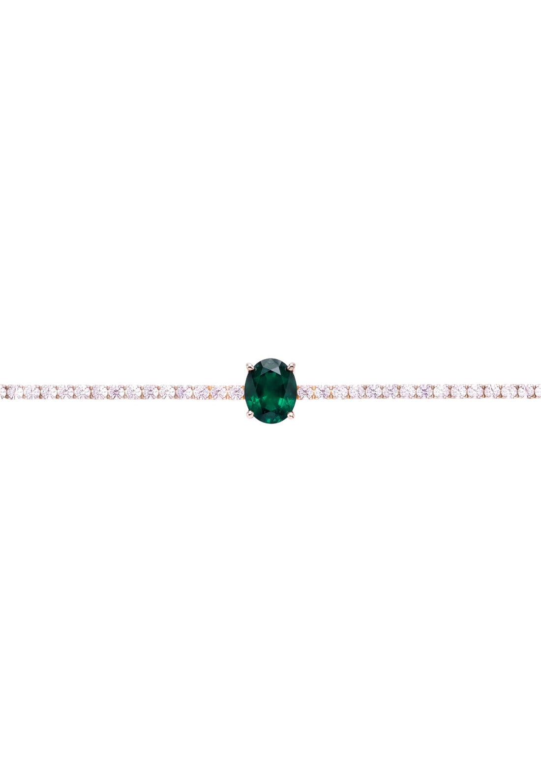 Silver tennis bracelet close-up with emerald green oval gemstone set in white stones