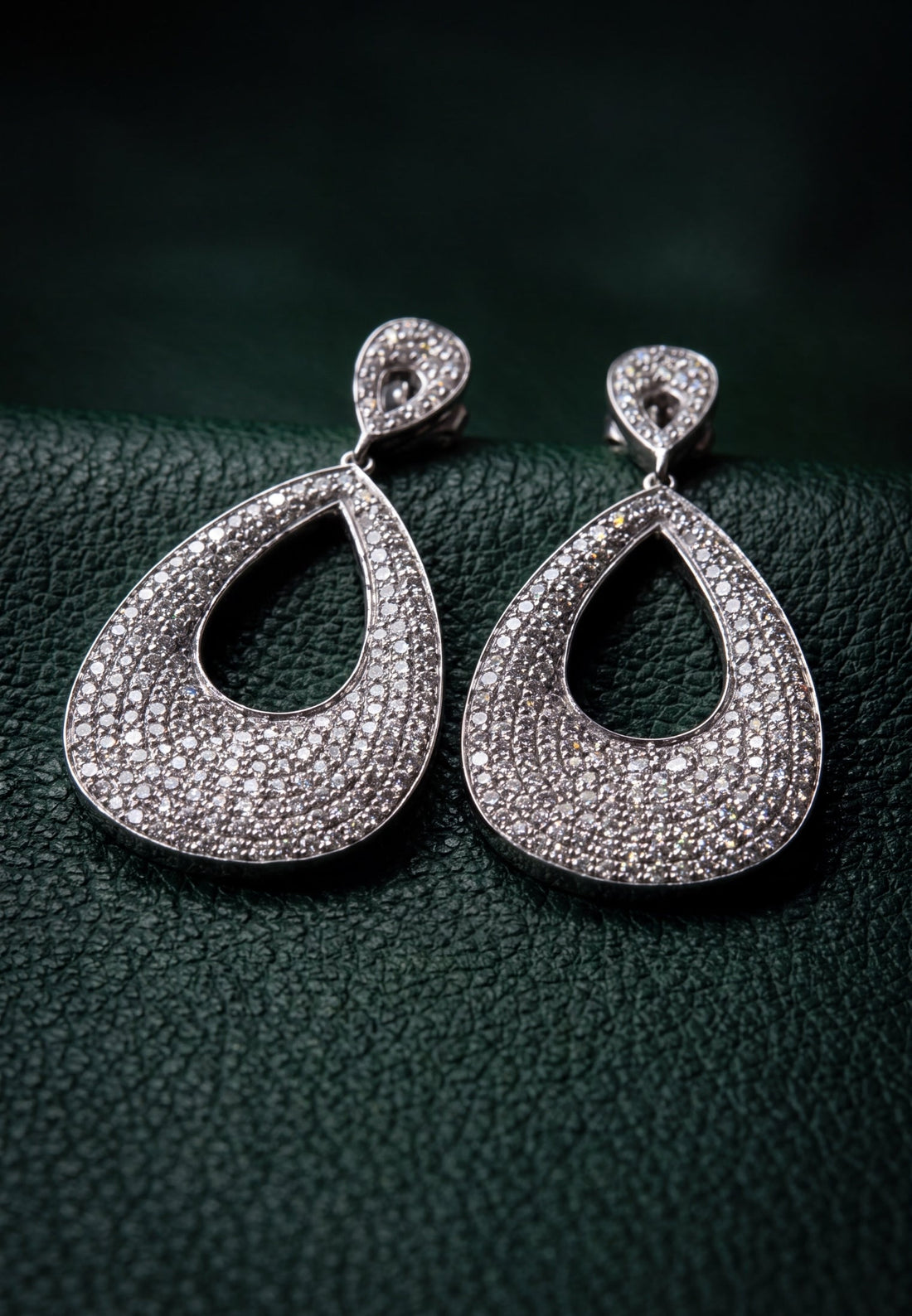 Silver teardrop earrings with pavé-set stones and open teardrop design